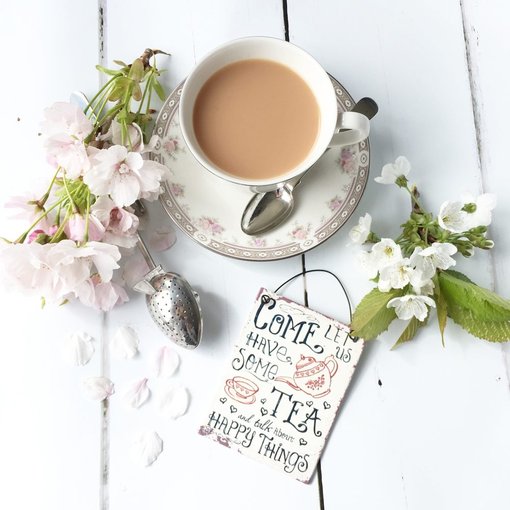 tea cup with flowers surrounding it